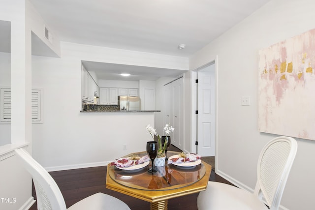 911 Washington St Unit 304, Raleigh, NC 27605 - dining space featuring baseboards and wood finished floors