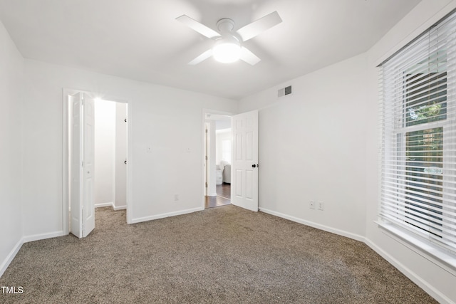 911 Washington St Unit 304, Raleigh, NC 27605 - unfurnished bedroom with carpet, baseboards, and a ceiling fan