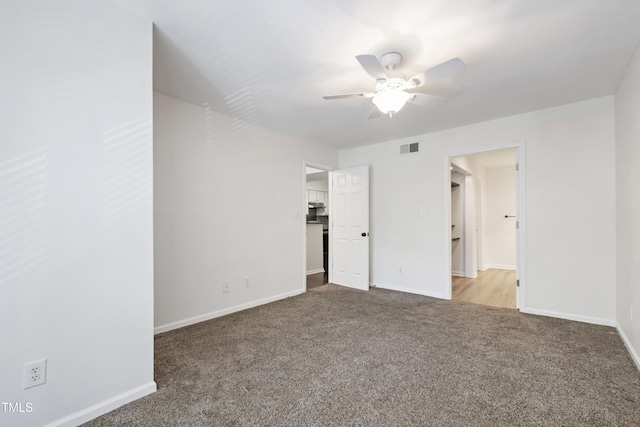 911 Washington St Unit 304, Raleigh, NC 27605 - unfurnished bedroom featuring carpet, baseboards, and a ceiling fan