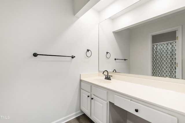 911 Washington St Unit 304, Raleigh, NC 27605 - bathroom featuring vanity, baseboards, and wood finished floors