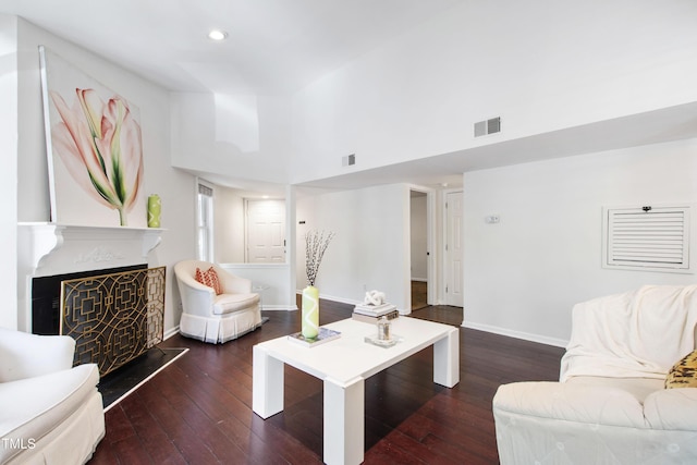 911 Washington St Unit 304, Raleigh, NC 27605 - living room with dark wood-type flooring, a high ceiling, recessed lighting, a fireplace with raised hearth, and baseboards