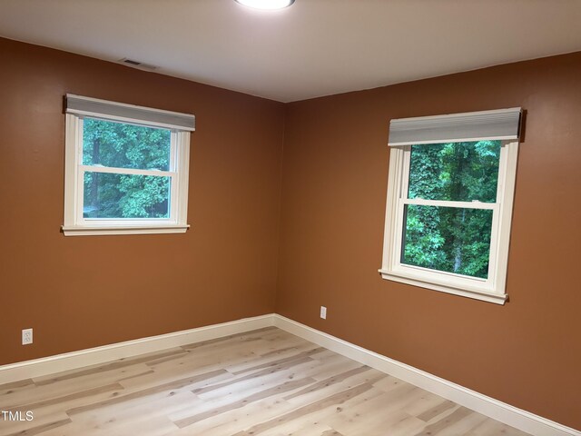 301 Roseland Ave, Durham, NC 27712 - spare room featuring baseboards and light wood-style flooring