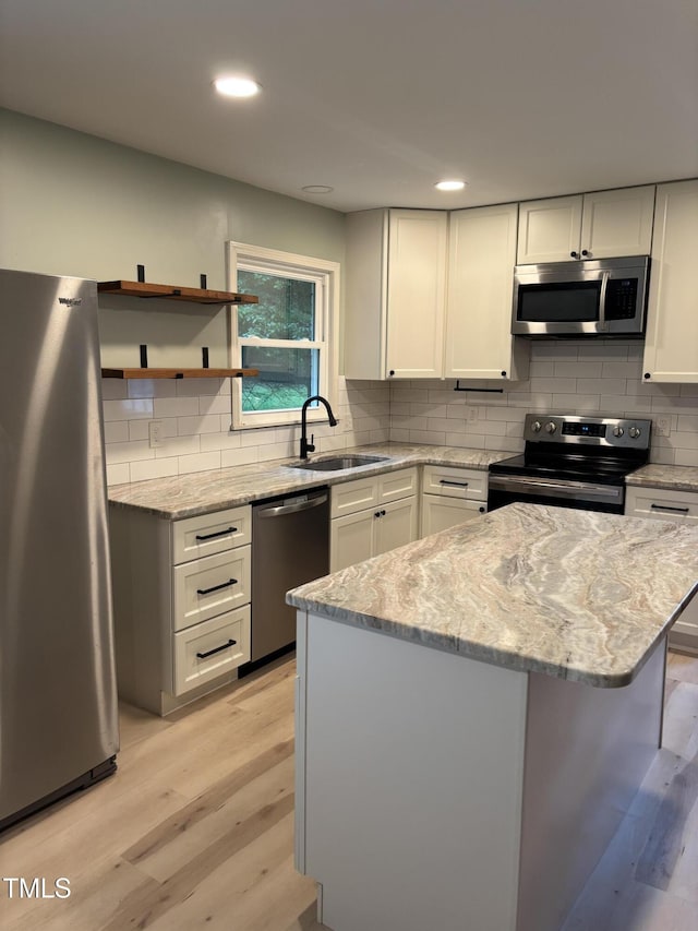 301 Roseland Ave, Durham, NC 27712 - kitchen featuring stainless steel appliances, light wood-type flooring, backsplash, light stone countertops, and recessed lighting