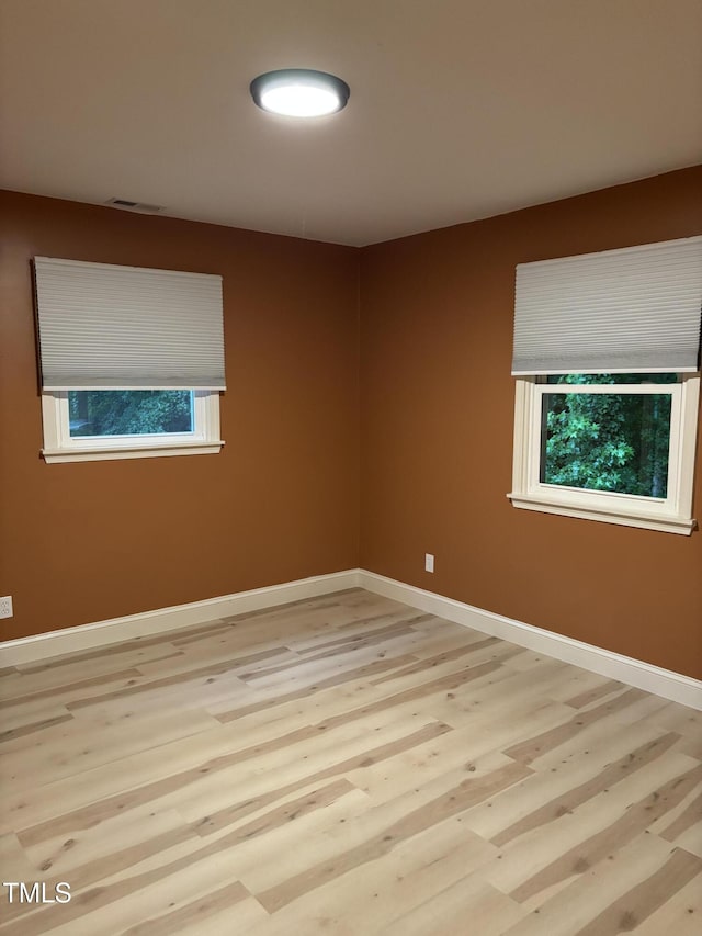 301 Roseland Ave, Durham, NC 27712 - empty room featuring light wood finished floors and healthy amount of natural light
