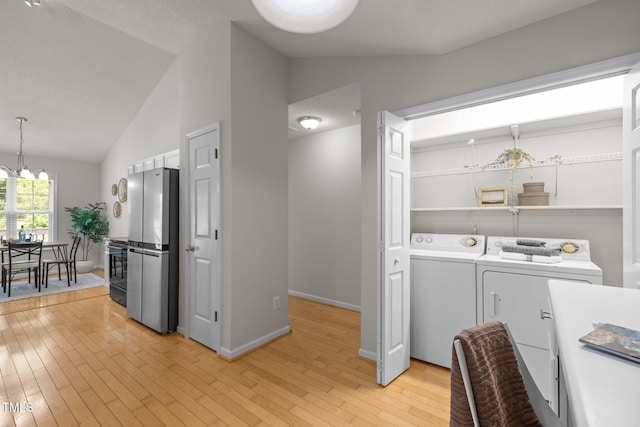 508 Hidden Cellars Dr, Holly Springs, NC 27540 - laundry room with washer and dryer, light wood-style flooring, and a chandelier