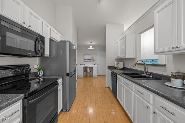 508 Hidden Cellars Dr, Holly Springs, NC 27540 - kitchen with black appliances, dark countertops, and white cabinets