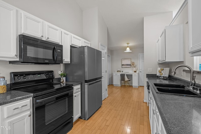 508 Hidden Cellars Dr, Holly Springs, NC 27540 - kitchen featuring black appliances, dark countertops, white cabinetry, and light wood finished floors