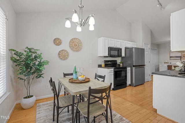 508 Hidden Cellars Dr, Holly Springs, NC 27540 - dining area featuring high vaulted ceiling, light wood-style floors, a chandelier, and track lighting