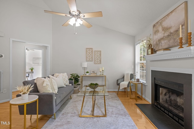 508 Hidden Cellars Dr, Holly Springs, NC 27540 - living area with a ceiling fan, wood finished floors, a fireplace with flush hearth, and high vaulted ceiling