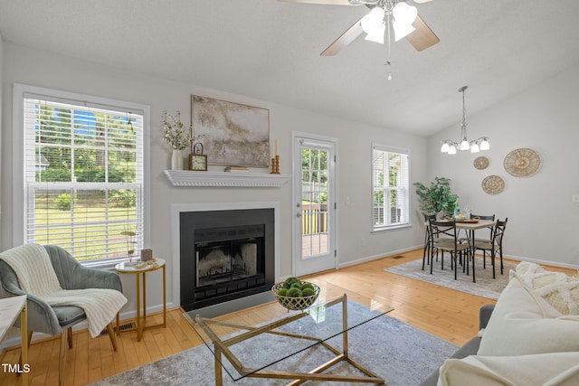 508 Hidden Cellars Dr, Holly Springs, NC 27540 - living area with wood-type flooring, plenty of natural light, a fireplace with flush hearth, lofted ceiling, and a ceiling fan