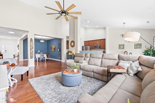 1400 Manley Ct, Fuquay Varina, NC 27526 - living area featuring light wood-type flooring, high vaulted ceiling, and a ceiling fan