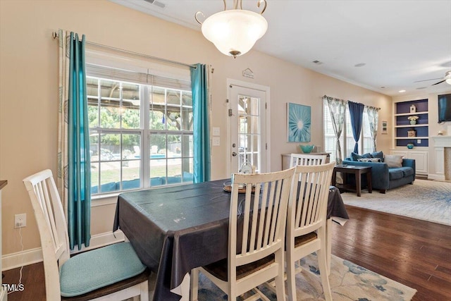 1161 Tulip Poplar Rd, Fuquay Varina, NC 27526 - dining space with healthy amount of natural light, wood finished floors, a ceiling fan, and built in features