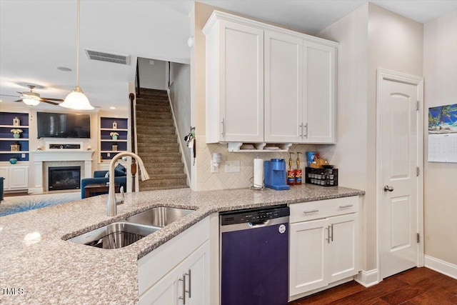 1161 Tulip Poplar Rd, Fuquay Varina, NC 27526 - kitchen featuring stainless steel dishwasher, a sink, dark wood-style flooring, a ceiling fan, and light stone countertops