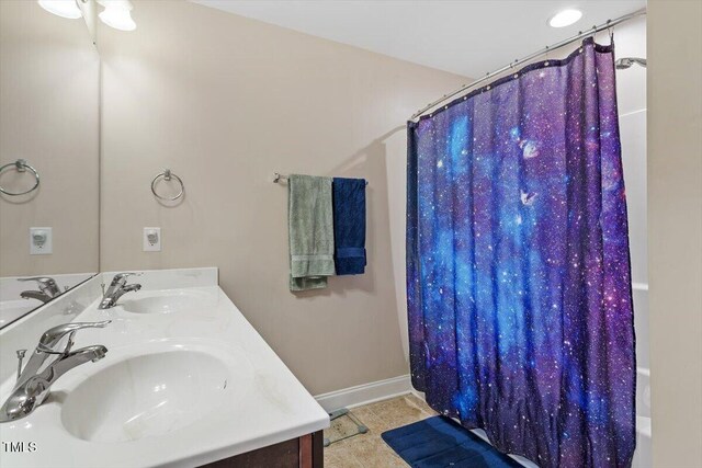 1161 Tulip Poplar Rd, Fuquay Varina, NC 27526 - bathroom with double vanity, baseboards, and tile patterned floors