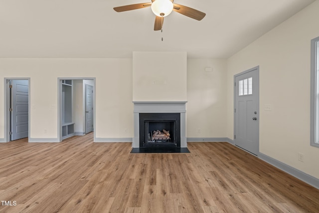 147 Harmony Trl, Broadway, NC 27505 - unfurnished living room featuring a ceiling fan, light wood-type flooring, baseboards, and a fireplace with flush hearth