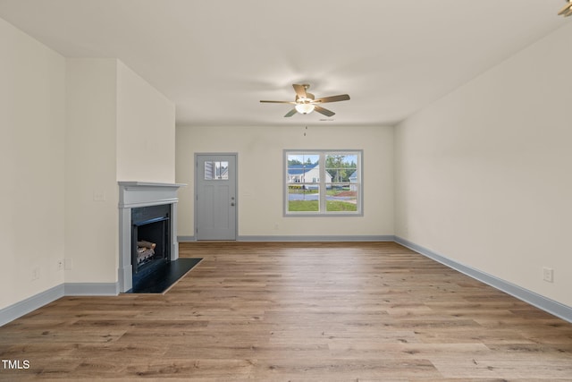 147 Harmony Trl, Broadway, NC 27505 - unfurnished living room featuring a fireplace, a ceiling fan, light wood finished floors, and baseboards