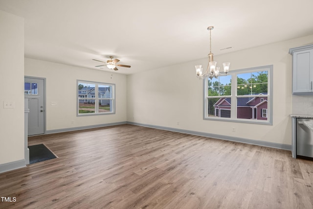 147 Harmony Trl, Broadway, NC 27505 - unfurnished dining area with light wood-style flooring, a chandelier, ceiling fan, and baseboards