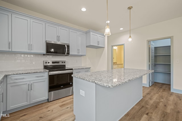 147 Harmony Trl, Broadway, NC 27505 - kitchen with stainless steel appliances, light wood-type flooring, backsplash, recessed lighting, and light stone counters