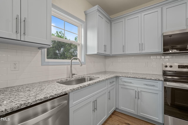 147 Harmony Trl, Broadway, NC 27505 - kitchen featuring stainless steel appliances, a sink, backsplash, and light stone countertops
