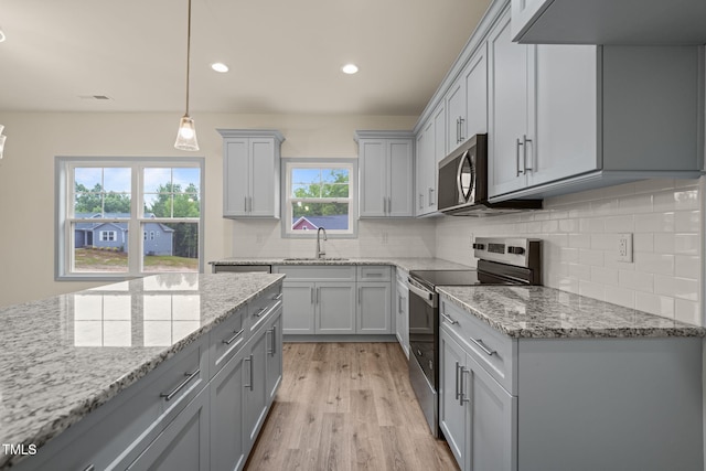 147 Harmony Trl, Broadway, NC 27505 - kitchen featuring appliances with stainless steel finishes, gray cabinets, a sink, decorative backsplash, and light stone countertops