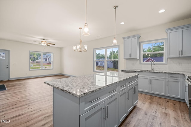 147 Harmony Trl, Broadway, NC 27505 - kitchen with gray cabinetry, a sink, light wood-style floors, plenty of natural light, and recessed lighting