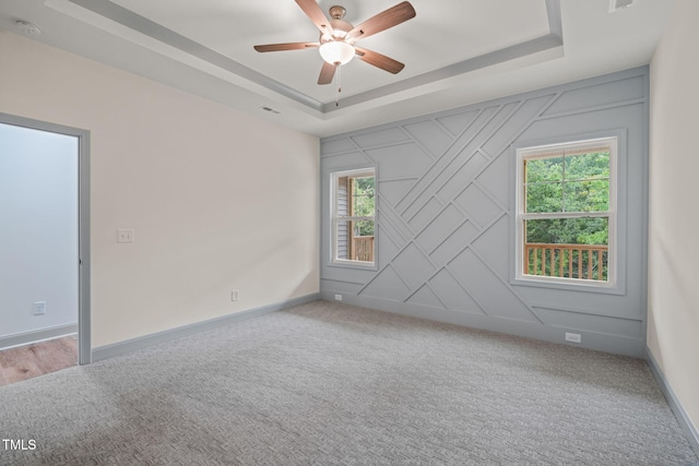 147 Harmony Trl, Broadway, NC 27505 - carpeted empty room featuring a tray ceiling, ceiling fan, a smoke detector, and baseboards