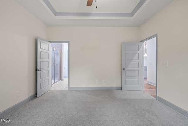 147 Harmony Trl, Broadway, NC 27505 - unfurnished bedroom featuring carpet, a tray ceiling, and baseboards