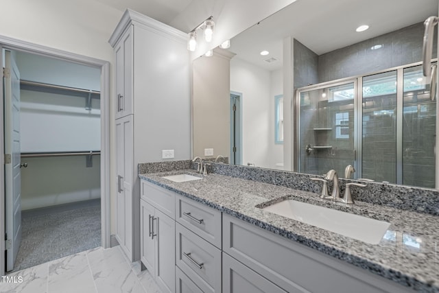 147 Harmony Trl, Broadway, NC 27505 - bathroom featuring double vanity, a stall shower, a walk in closet, marble look tile flooring, and recessed lighting