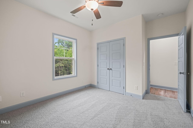 147 Harmony Trl, Broadway, NC 27505 - unfurnished bedroom featuring carpet, baseboards, a closet, and a ceiling fan