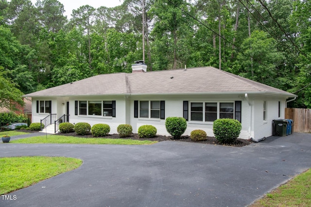 3934 Hope Valley Rd, Durham, NC 27707 - ranch-style house with brick siding, a chimney, asphalt driveway, and a shingled roof