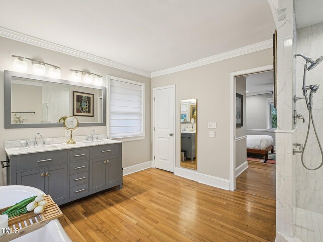 3934 Hope Valley Rd, Durham, NC 27707 - ensuite bathroom with double vanity, tiled shower, wood finished floors, crown molding, and baseboards