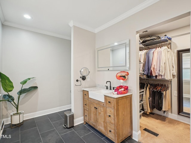 3934 Hope Valley Rd, Durham, NC 27707 - bathroom with vanity, ornamental molding, a walk in closet, tile patterned flooring, and baseboards