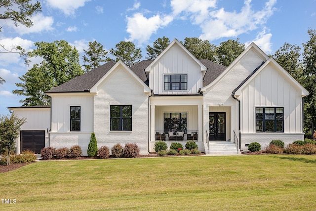 2328 Sanctuary Dr, Raleigh, NC 27606 - modern farmhouse style home with board and batten siding, a front yard, brick siding, covered porch, and a shingled roof
