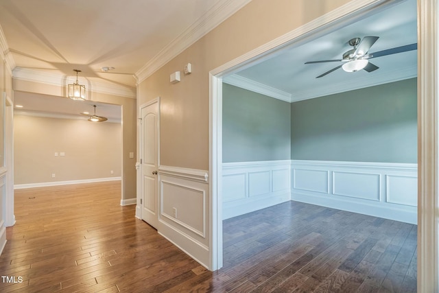 20 Sugarpine Trl, Clayton, NC 27520 - spare room with dark wood-style flooring, wainscoting, crown molding, and a ceiling fan