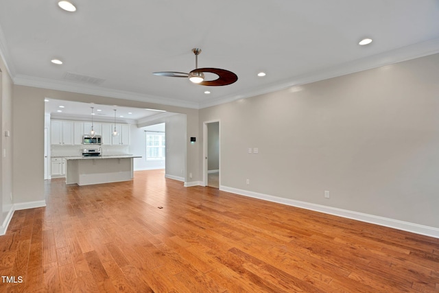 20 Sugarpine Trl, Clayton, NC 27520 - unfurnished living room featuring ceiling fan, light wood-style flooring, ornamental molding, recessed lighting, and baseboards