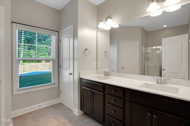 20 Sugarpine Trl, Clayton, NC 27520 - full bathroom featuring double vanity, a shower stall, baseboards, and tile patterned floors