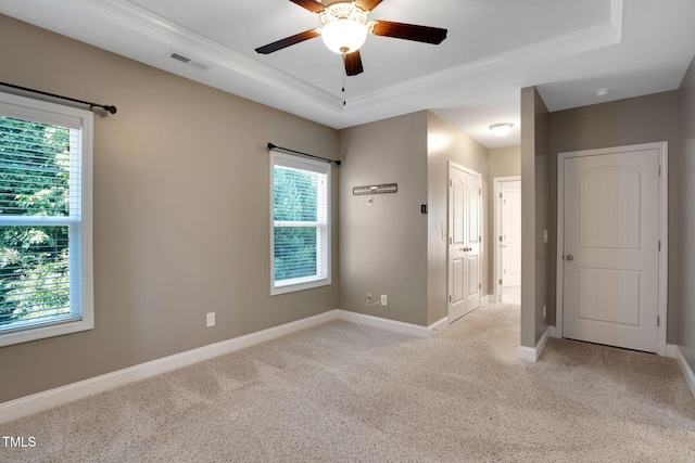 20 Sugarpine Trl, Clayton, NC 27520 - spare room with ornamental molding, light colored carpet, a tray ceiling, healthy amount of natural light, and a ceiling fan