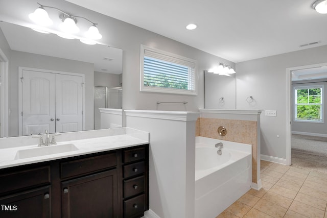 20 Sugarpine Trl, Clayton, NC 27520 - bathroom featuring a bath, vanity, tile patterned floors, baseboards, and an enclosed shower