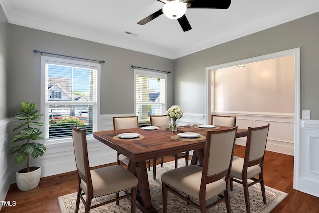 20 Sugarpine Trl, Clayton, NC 27520 - dining room featuring wainscoting, ornamental molding, dark wood finished floors, ceiling fan, and a decorative wall