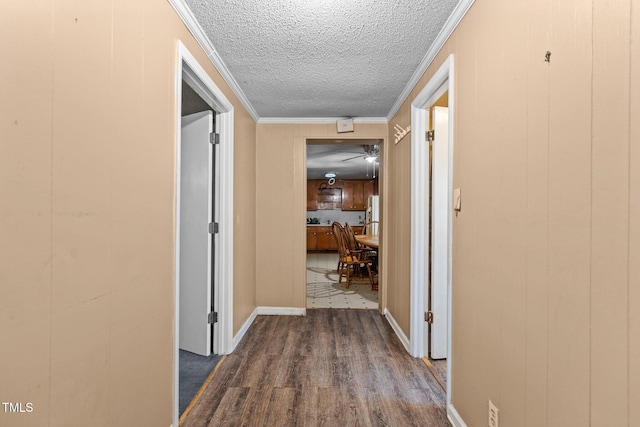 4038 Redwood Rd, Durham, NC 27704 - corridor featuring dark wood-type flooring, a textured ceiling, crown molding, and baseboards