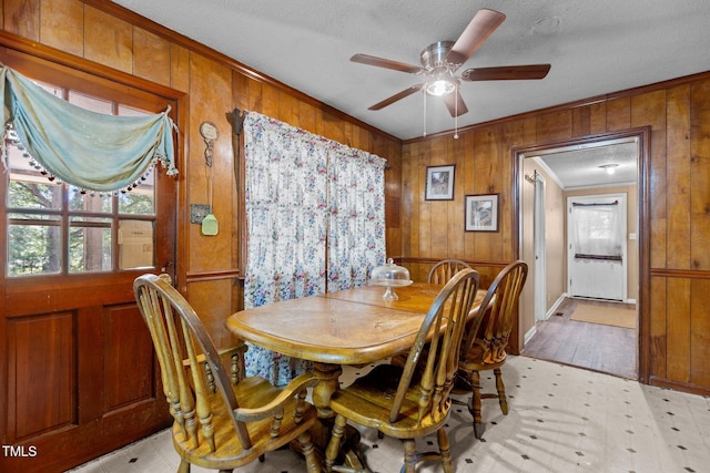 4038 Redwood Rd, Durham, NC 27704 - dining space with ornamental molding, wooden walls, healthy amount of natural light, a textured ceiling, and ceiling fan