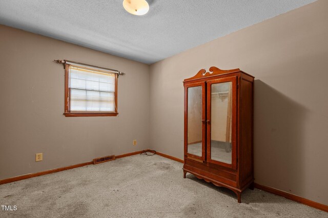 4038 Redwood Rd, Durham, NC 27704 - carpeted empty room with a textured ceiling and baseboards