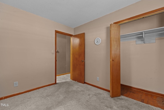 4038 Redwood Rd, Durham, NC 27704 - unfurnished bedroom with a closet, baseboards, and carpet flooring
