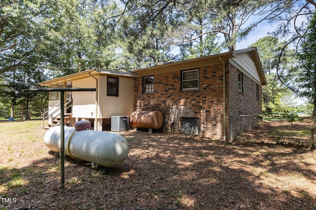 4038 Redwood Rd, Durham, NC 27704 - rear view of property with brick siding, central air condition unit, entry steps, and heating fuel