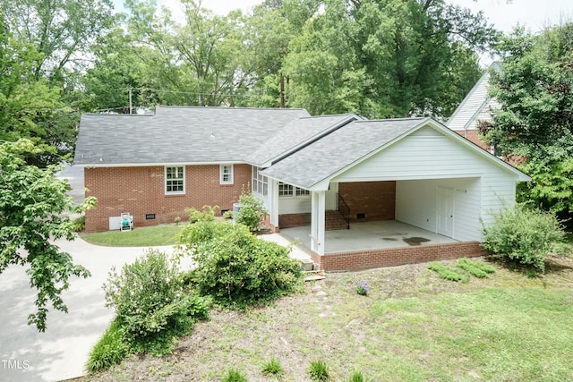 303 Spring St, Louisburg, NC 27549 - back of property featuring roof with shingles, brick siding, a lawn, and view of wooded area