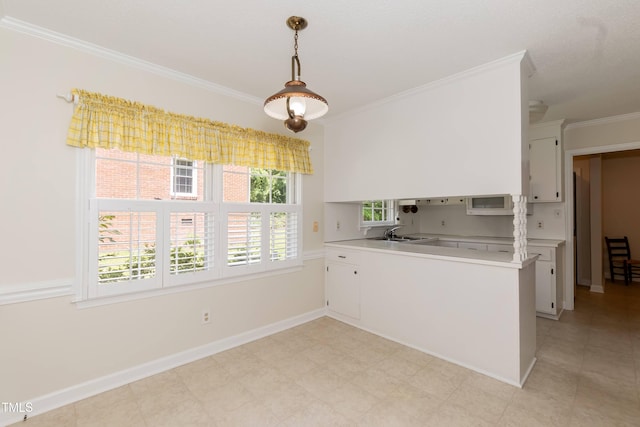 303 Spring St, Louisburg, NC 27549 - kitchen featuring ornamental molding, white microwave, a sink, light countertops, and white cabinetry