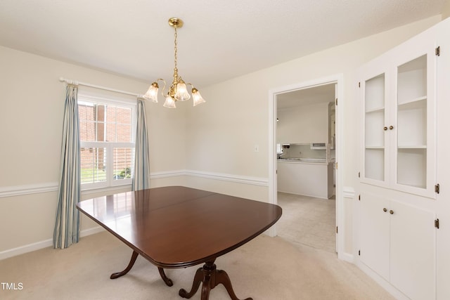 303 Spring St, Louisburg, NC 27549 - dining room featuring a chandelier, light colored carpet, and baseboards