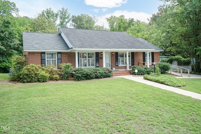 303 Spring St, Louisburg, NC 27549 - single story home featuring brick siding, a front yard, and covered porch
