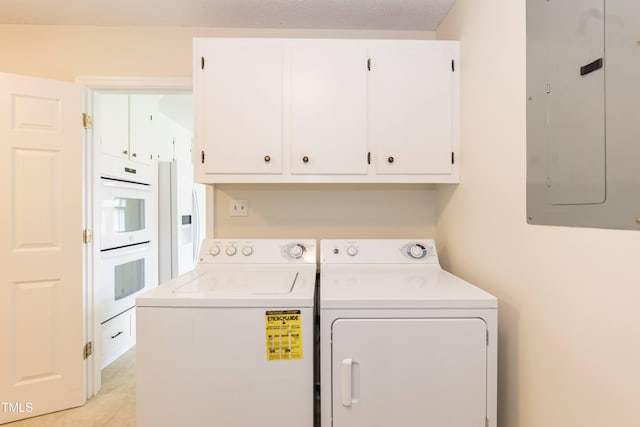 303 Spring St, Louisburg, NC 27549 - laundry room featuring cabinet space, electric panel, washer and clothes dryer, and light tile patterned flooring