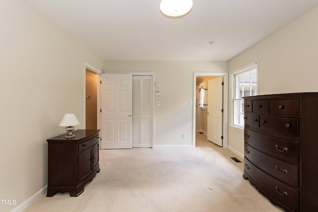 303 Spring St, Louisburg, NC 27549 - bedroom featuring baseboards, light carpet, and a closet